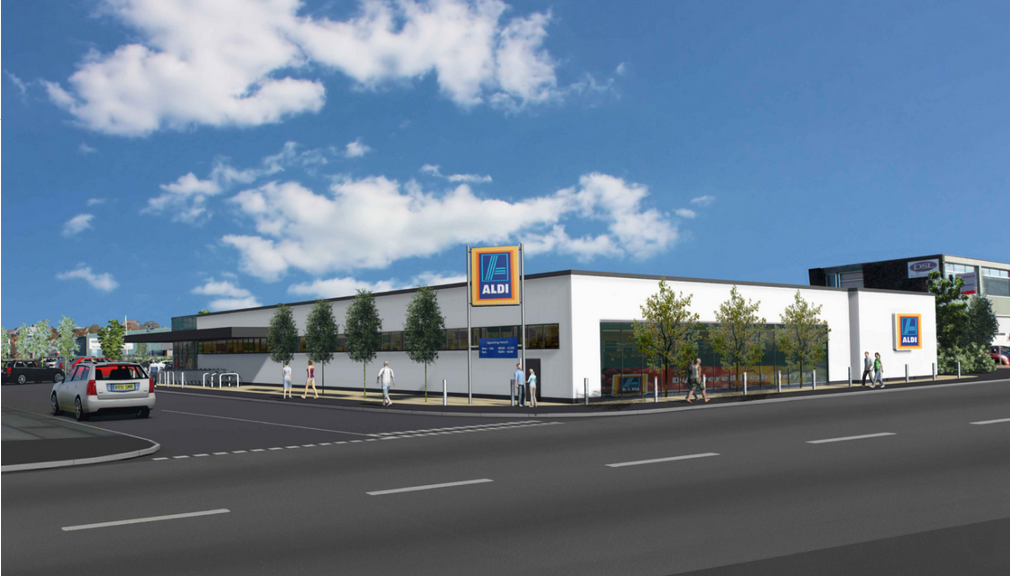 Aldi store front with shopping carts and customers entering the building.