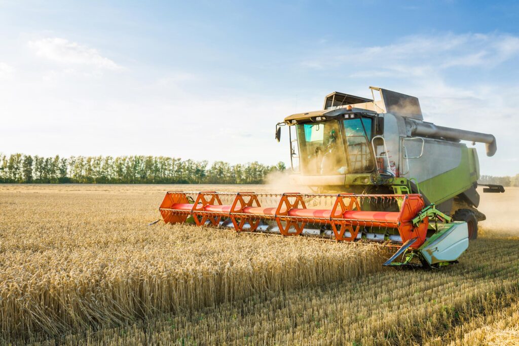 A combine harvester harvesting crops in a field.